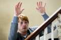 Rupert_Grint_(Tony)_looking_over_the_banisters_with_his_hands_raised_[3358_Photo__Nick_Wall].jpg