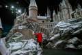 Lucky_local_girl_Robyn_aged_7_adds_the_last_sprinkles_of_snow_onto_the_Hogwarts_model_at_Warner_Bros__Studio_Tour_London_(4).jpg